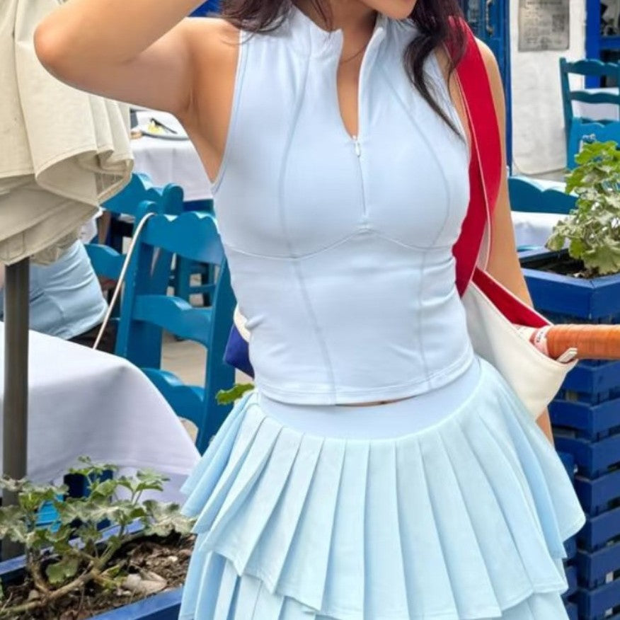 Women's sky blue sleeveless tennis top with pleated skirt